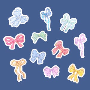 May include: A set of ten colorful bow stickers with a sparkly design. The bows are in various colors, including pink, blue, yellow, and green.