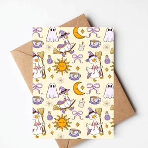 May include: Greeting card with a whimsical Halloween pattern. The design features a repeating pattern of witch geese riding brooms, ghosts, moons, suns, teacups, bows, and potion bottles on a cream background. The card is paired with a brown envelope.