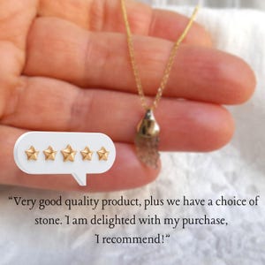 May include: Five gold stars in a row on a white speech bubble, with the text "Very good quality product, plus we have a choice of stone. I am delighted with my purchase, I recommend!" below. A hand is holding a gold chain necklace with a gold pendant.