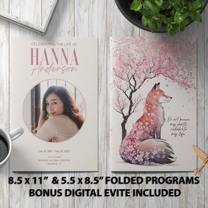 May include: A funeral programme template with a pink and white floral design. The front cover features a photo of a woman in a circle and the text "Celebrating the life of Hanna Anderson". The back cover features a fox sitting under a pink cherry blossom tree with the text "Do not mourn my death, celebrate my life." The programme is 8.5 x 11 inches and 5.5 x 8.5 inches when folded.