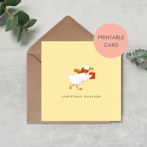 May include: A yellow printable Christmas card featuring a white duck wearing a brown scarf and carrying a red gift box. The text "Christmas Quacker" is printed below the duck.