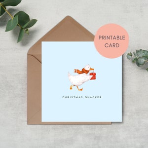 May include: A printable Christmas card featuring a white duck wearing a brown scarf and carrying a red gift box. The text "Christmas Quacker" is printed below the duck.