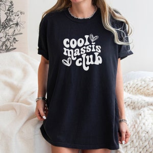 May include: Black oversized t-shirt with white text that reads "cool massis club" and two white hearts.