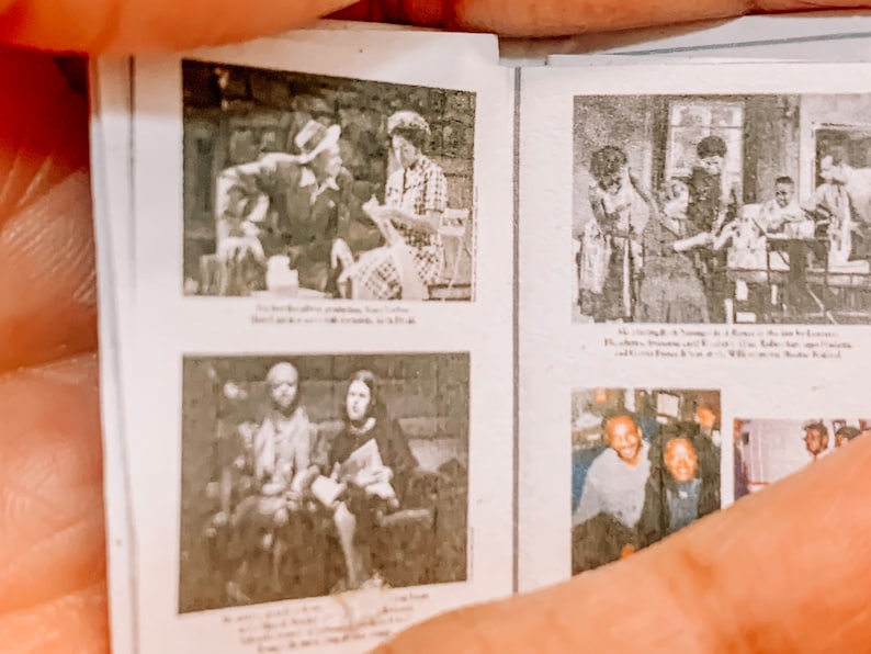 May include: A black and white photo album with several pictures of people. The album is open to a page with two photos. The top photo shows a group of people sitting at a table. The bottom photo shows two people sitting on a sofa.