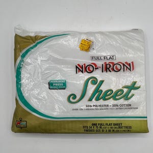 May include: A full flat sheet in a clear plastic package. The sheet is white with the words "NO-IRON Sheet" in red and green. The package states the sheet fits a 54 x 75 inch mattress and is 81 x 96 inches finished.