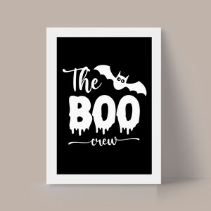 May include: A black and white printable sign with the text "The Boo Crew" and a white silhouette of a bat with dripping blood.