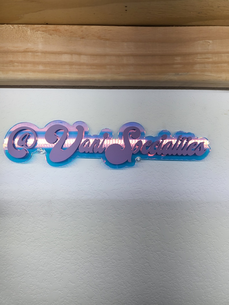 May include: A blue and purple sign with the text "@Dani Specialties" in pink lettering.