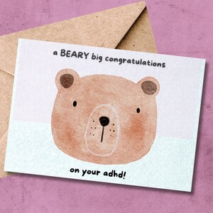May include: A light blue card with a brown bear illustration and the text "a BEARY big congratulations on your adhd!"