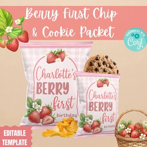May include: Pink and white checkered chip and cookie packets with strawberry illustrations. The text on the packets reads "Charlotte's BERRY first birthday". A chocolate chip cookie and a basket of strawberries are also visible.