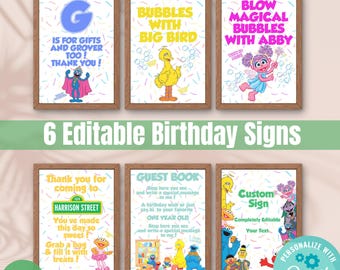 May include: Six framed Sesame Street birthday signs with various characters and phrases like "Bubbles with Big Bird" and "Thank you for coming to." The signs are in wooden frames and feature colorful designs.