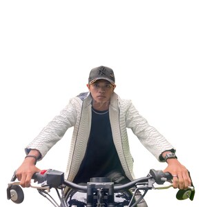 May include: A person wearing a white textured jacket and a black baseball cap, riding a motorcycle. The jacket has a reptile-like pattern. The motorcycle has black handlebars and a black seat.