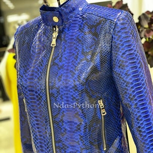 May include: A blue snakeskin leather jacket with a zipper closure and side pockets.