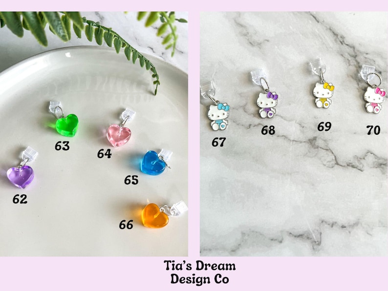 May include: A collection of charms featuring hearts and Hello Kitty characters. The charms are made of clear plastic and have different colors, including green, pink, blue, and orange. The charms are numbered 62 through 70.