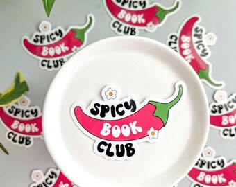 May include: A set of nine red chili pepper stickers with the text "Spicy Book Club" in black lettering. The stickers are on a white surface.