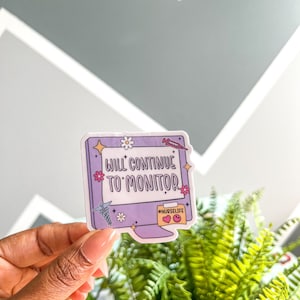 May include: Purple computer monitor sticker with the text "Will Continue to Monitor" and the hashtag "#NurseLife".