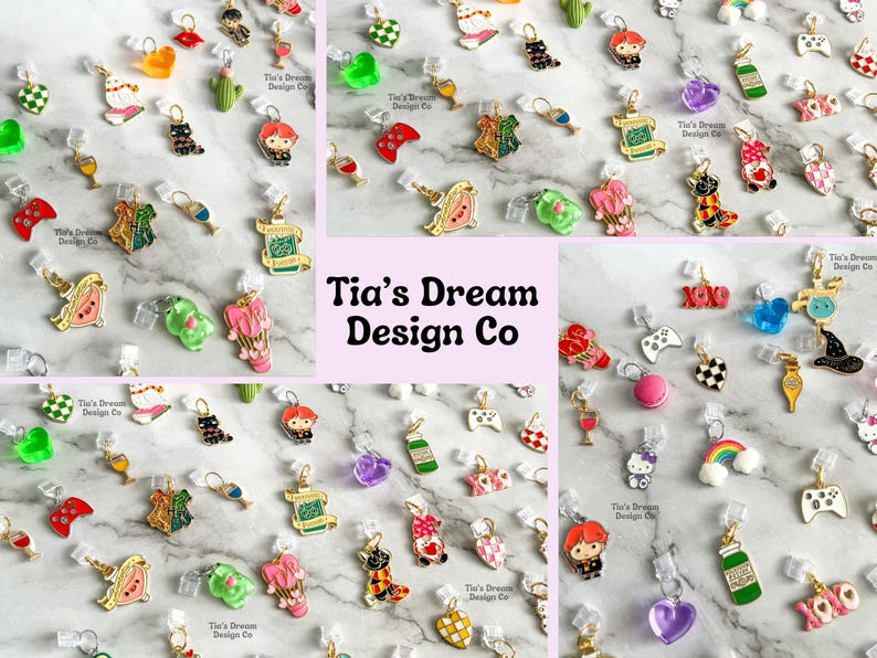 May include: Assortment of colorful enamel charms with various designs, including hearts, animals, food, and gaming-themed charms. The charms are attached to clear plastic clasps. The charms are arranged on a white surface with a green and white patterned background. The text "Tia's Dream Design Co" is visible in the center of the image.