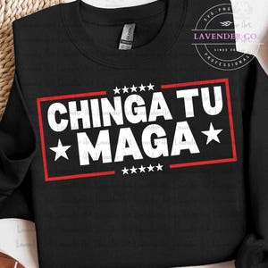 May include: Black sweatshirt with the text "CHINGA TU MAGA" in white, inside a red rectangle. The design includes white stars above and below the text. The sweatshirt has a crew neck and long sleeves.