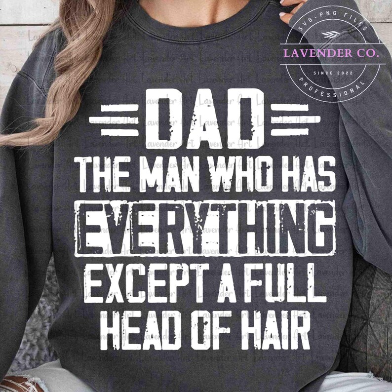 May include: Dark gray sweatshirt with white text that reads "DAD THE MAN WHO HAS EVERYTHING EXCEPT A FULL HEAD OF HAIR." The text is in a bold, sans-serif font. The sweatshirt has long sleeves and a crew neck.