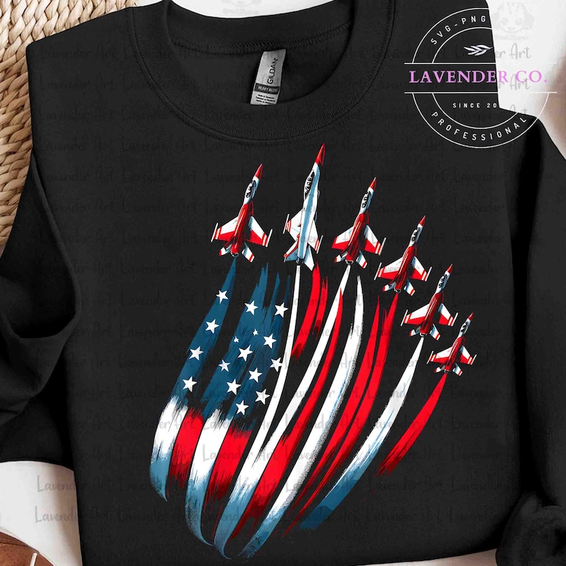 May include: Black sweatshirt featuring a graphic of six red, white, and blue fighter jets in formation, with the American flag design as a backdrop. The jets leave white vapor trails. The text "LAVENDER CO." is in the upper right corner.