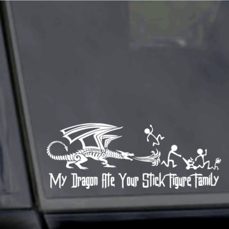 May include: White vinyl sticker with a dragon blowing fire at stick figure people. The text reads "My Dragon Ate Your Stick Figure Family."