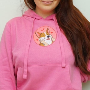 Sudadera rosa con un lindo perro corgi