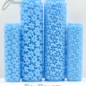 May include: Four blue textured rollers with a tiny flower design. The rollers are different sizes and are labeled "Tiny Flowers Deep Texture".