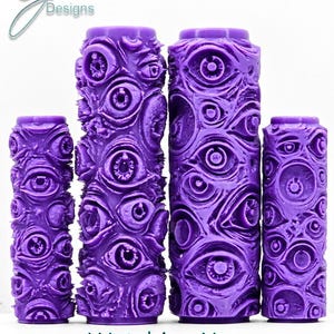 May include: Four purple cylindrical paint rollers featuring an intricate, raised pattern of numerous human-like eyes across the entire surface. The text G Designs, Watching You, and Ultra Deep Impression is visible in the image.