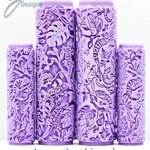May include: Four purple cylindrical rollers featuring detailed lizard and plant patterns. The rollers are of varying heights and are displayed in a line. The text "Lounging Lizards Intricate Texture" is visible at the bottom.