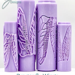 May include: Four purple rolling pins with dragonfly wing designs. The rolling pins are different sizes and have intricate details.