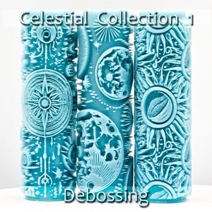 May include: Three cylindrical light blue rollers for debossing, each featuring intricate celestial patterns including stars, moons, and suns. The text Celestial Collection 1 Debossing is overlaid on the image. The rollers have a textured surface.
