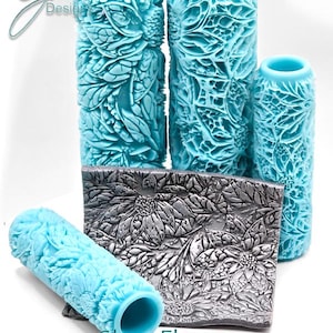 May include: A collection of textured, light blue paint rollers and a rectangular plate with a floral design. The rollers vary in size, and the plate is silver. The text "Glass Flowers Deep Impression" is at the bottom.
