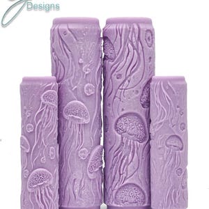 May include: Four purple textured rolling pins with a jellyfish design. The rolling pins are different sizes.  Jellyfish Intricate Texture.