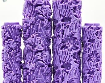 May include: A set of five purple Iris UltraDeep Texture rollers. The rollers are cylindrical with a detailed floral pattern. The image includes the text "Iris" and "UltraDeep Texture" in green.