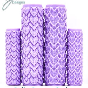 May include: Four cylindrical rollers in light purple featuring a raised dragon scale texture. The two central rollers are taller than the two outer rollers. The text G Designs, Bulky Dragon Scales, and Intricate Texture appear on the image.