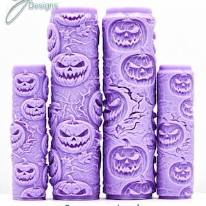 May include: Four cylindrical purple rollers featuring a raised, embossed pattern of jack-o'-lanterns with jagged smiles and carved eyes, surrounded by textured branches. The text "G Designs" appears in the top left, and "Creepy Jack Intricate Texture" is at the bottom.