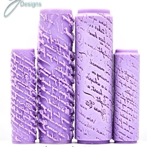 May include: Four cylindrical lavender rollers featuring embossed cursive script text. Two rollers display a deeply textured, raised pattern of handwritten love letters, while the other two feature a smoother, flatter surface with similar script.