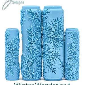 May include: Four light blue cylindrical rollers with a raised, intricate fern-like pattern. The text G Designs, Winter Wonderland, and Deep Texture appears in the image. These tools feature a repeating botanical design across their surfaces.