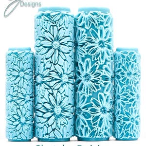May include: Four light blue cylindrical rollers featuring a raised, embossed pattern of daisies. The text G Designs appears in the top left corner, and the text Sketchy Daisies Deep Impression is printed at the bottom of the image.