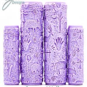 May include: Four cylindrical purple paint rollers featuring embossed patterns of prehistoric-style cave art, including human figures, animals, handprints, and spiral motifs. The text G Designs, Cavern Walls, and Intricate Texture is visible.