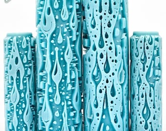 May include: A collection of five turquoise cylinders with a drip design. The cylinders vary in height and feature a textured surface with a pattern of flowing drips and small holes. The text "Drips Deep Impression" is at the bottom.