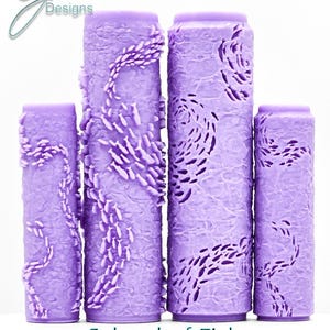 May include: Four cylindrical purple paint rollers with embossed fish patterns. The rollers feature varying sizes and designs of schools of fish. Text at the top reads G Designs, and text at the bottom reads School of Fish Intricate Texture.