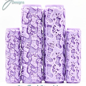 May include: Four lavender-colored, cylindrical objects with a detailed pattern of Christmas stockings and foliage. The text "Stuffed Stockings Intricate Texture" is displayed at the bottom. The objects vary in height.