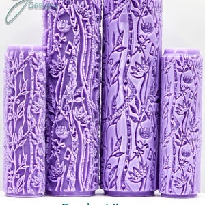 May include: Four lavender-colored rolling pins with a detailed vine and floral pattern. The rolling pins vary in height, with the tallest one prominently displayed. The text "Funky Vines Intricate Texture" is at the bottom.