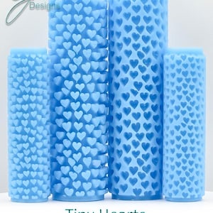 May include: Four blue rolling pins with a tiny heart pattern. The rolling pins are different sizes. The text "Tiny Hearts Deep Texture" is below the rolling pins.