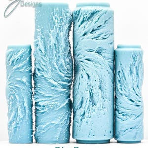 May include: Four light blue textured rollers with a unique, deep impression design. The rollers are cylindrical with a textured surface, and the text "Big Bang Deep Impression" is printed at the bottom. The rollers vary in height.