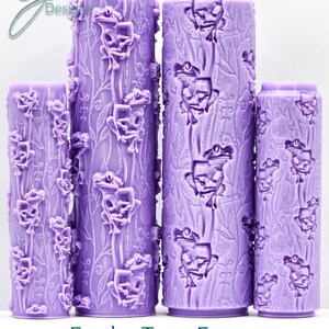 May include: Four cylindrical, lavender-colored objects with a textured surface. The objects are decorated with a repeating pattern of frogs and foliage. The text "Funky Tree Frogs Intricate Texture" is at the bottom.