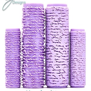 May include: Four cylindrical lavender paint rollers with a raised, embossed handwritten script texture. The rollers vary in height and are arranged in a row. The text G Designs is in the top left corner, and Handwritten Intricate Texture is below.