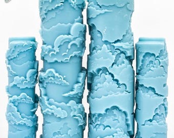 May include: Four light blue patterned paint rollers featuring a raised, embossed cloudy sky design. The rollers are arranged in a row, with the two taller ones in the center and the two shorter ones on the sides. Text reads G Designs and Cloudy Sky Deep Impression.