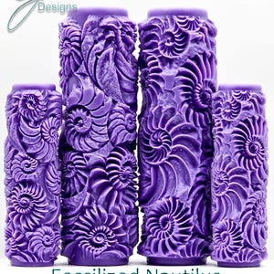 May include: Four purple cylindrical rollers with a fossilized nautilus design. The rollers are of varying heights and feature an ultra-deep texture. The text at the bottom reads "Fossilized Nautilus Ultra Deep Texture."