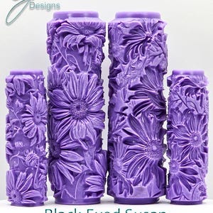 May include: Four purple paint rollers with a deep textured design of black-eyed susans. The text "Black Eyed Susan Ultra Deep Texture" is printed below the rollers.